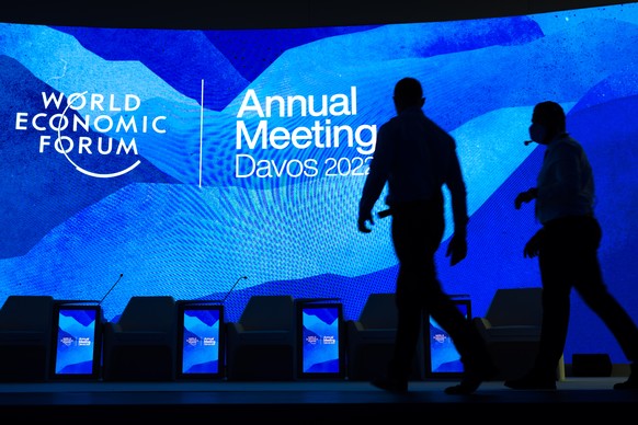 epa09965136 Workers set the stage prior the annual meeting of the World Economic Forum (WEF) in Davos, Switzerland, 22 May 2022. The forum begins 22 May, after being postponed due to the COVID-19 outb ...