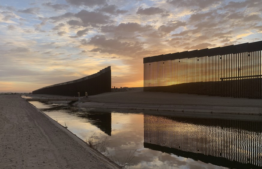 The sun sets above the U.S.-Mexico border wall, seen in Yuma, Ariz., Wednesday, June 9, 2021. The Biden administration says it has identified more than 3,900 children separated from their parents at t ...