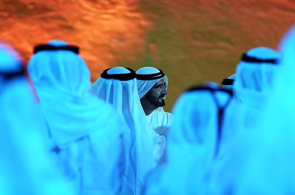 Dubai ruler Sheikh Mohammed bin Rashid Al Maktoum, center, talks to Emirati officials after announcing a UAE Mars mission named &quot;Hope&quot; — or &quot;al-Amal&quot; in Arabic — which is scheduled ...