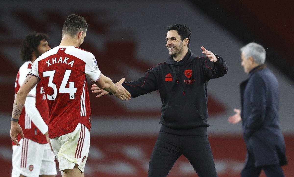 Arsenal's manager Mikel Arteta greets Arsenal's Granit Xhaka at the end of during the English Premier League soccer match between Arsenal and Tottenham Hotspur at the Emirates stadium in Lon ...