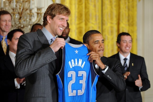 epa03054640 Dallas Mavericks power forward German Dirk Nowitzki (L) presents US President Barack Obama (R) with a Mavericks team jersey during a ceremony in the East Room of the White House in Washing ...