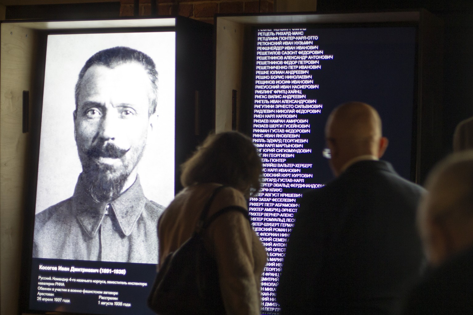 FILE - In this Friday, Oct. 30, 2015 file photo, visitors look at an exposition at the opening of the Gulag history museum in Moscow, Russia. A museum studying the history of Soviet prison camps said  ...