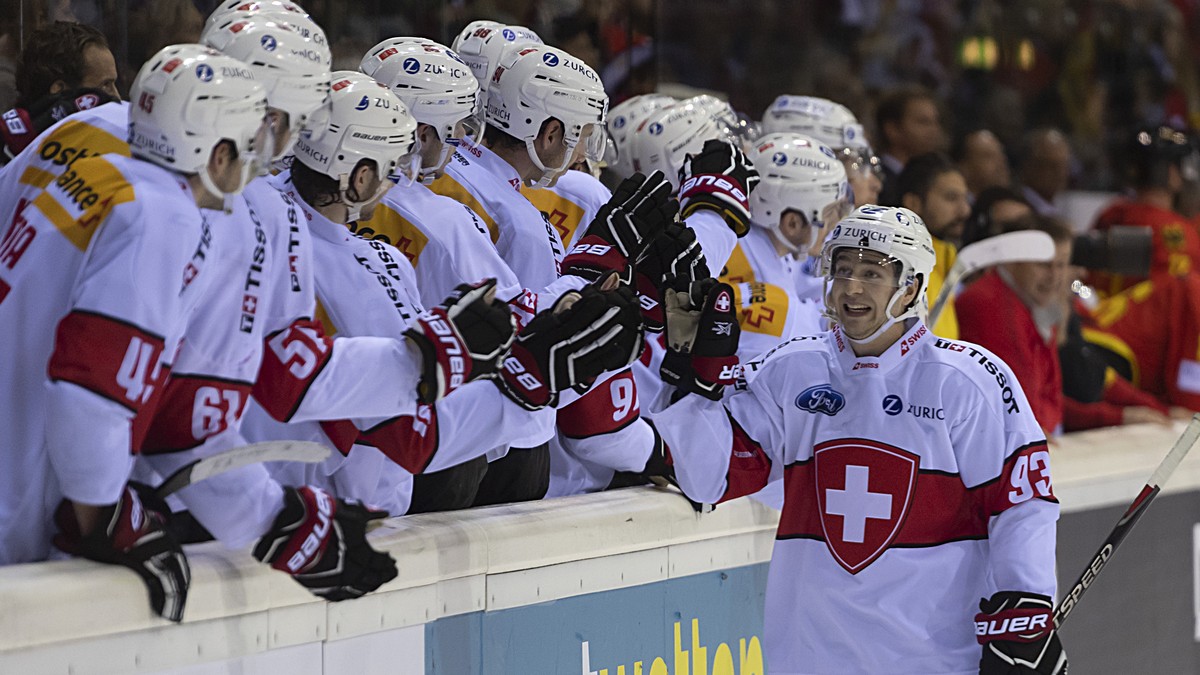 Switzerland's Lino Martschini, right, cheers after scoring during the penalty shoot-out of the Ice Hockey Deutschland Cup match between Germany and Switzerland at the Koenig Palast stadium in Kre ...
