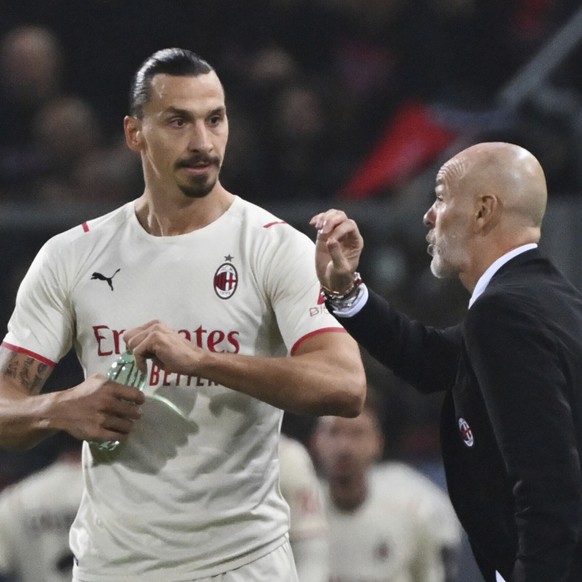 AC Milan's Stefano Pioli gives instructions to Zlatan Ibrahimovic during the Italian Serie A soccer match between Bologna and AC Milan at Renato Dall'Ara stadium in Bologna, Italy, Saturday, Oct. 23,  ...