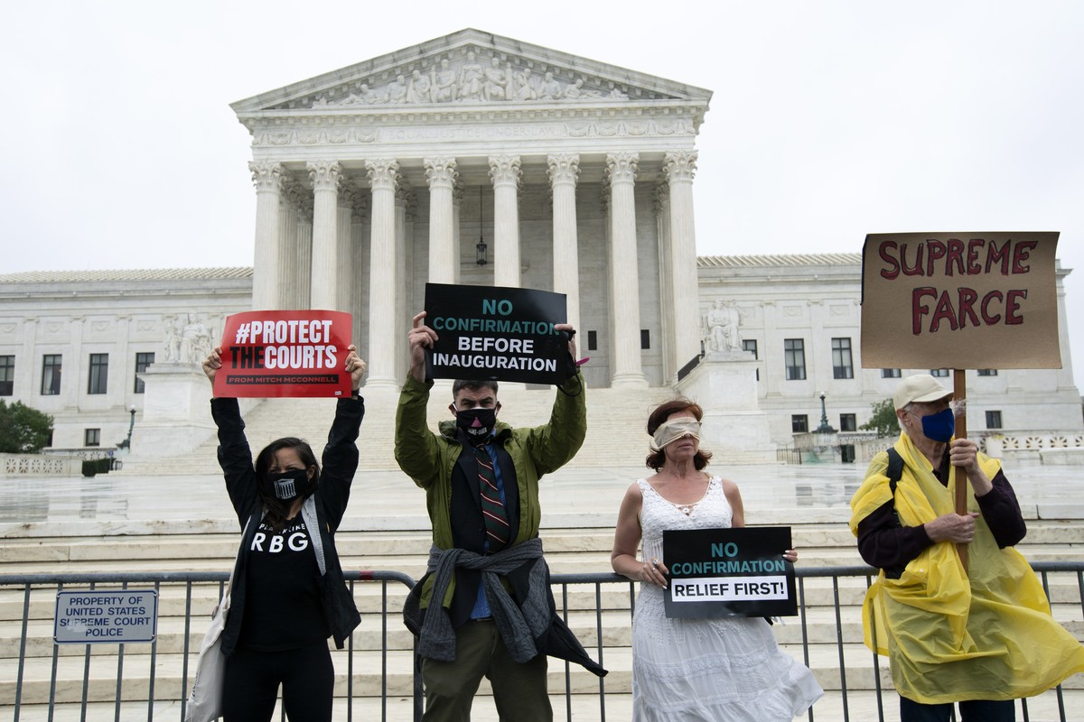 Protesters opposed to the confirmation of President Donald Trump's Supreme Court nominee Amy Coney Barrett, rally at the Supreme Court in Washington, Monday, Oct. 12, 2020. Barrett's confirm ...