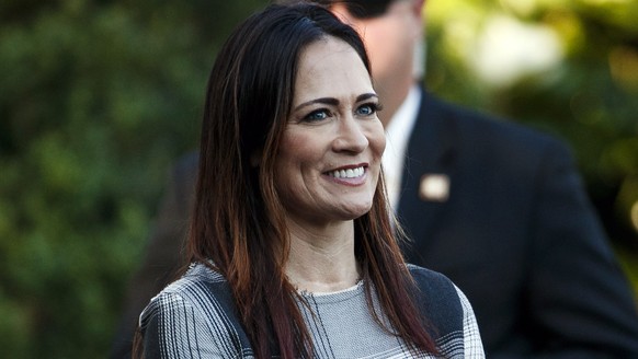 In this June 21, 2019 photo, Stephanie Grisham, spokeswoman for first lady Melania Trump, watches as President Donald Trump and the first lady greet attendees during the annual Congressional Picnic on ...