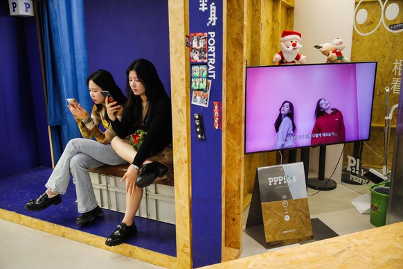 epa10664564 People use their cellphone in a shopping mall in Beijing, China, 31 May, 2023. China&#039;s official manufacturing purchasing managers Index (PMI) fell to 48.8 percent in May from 49.2 fro ...