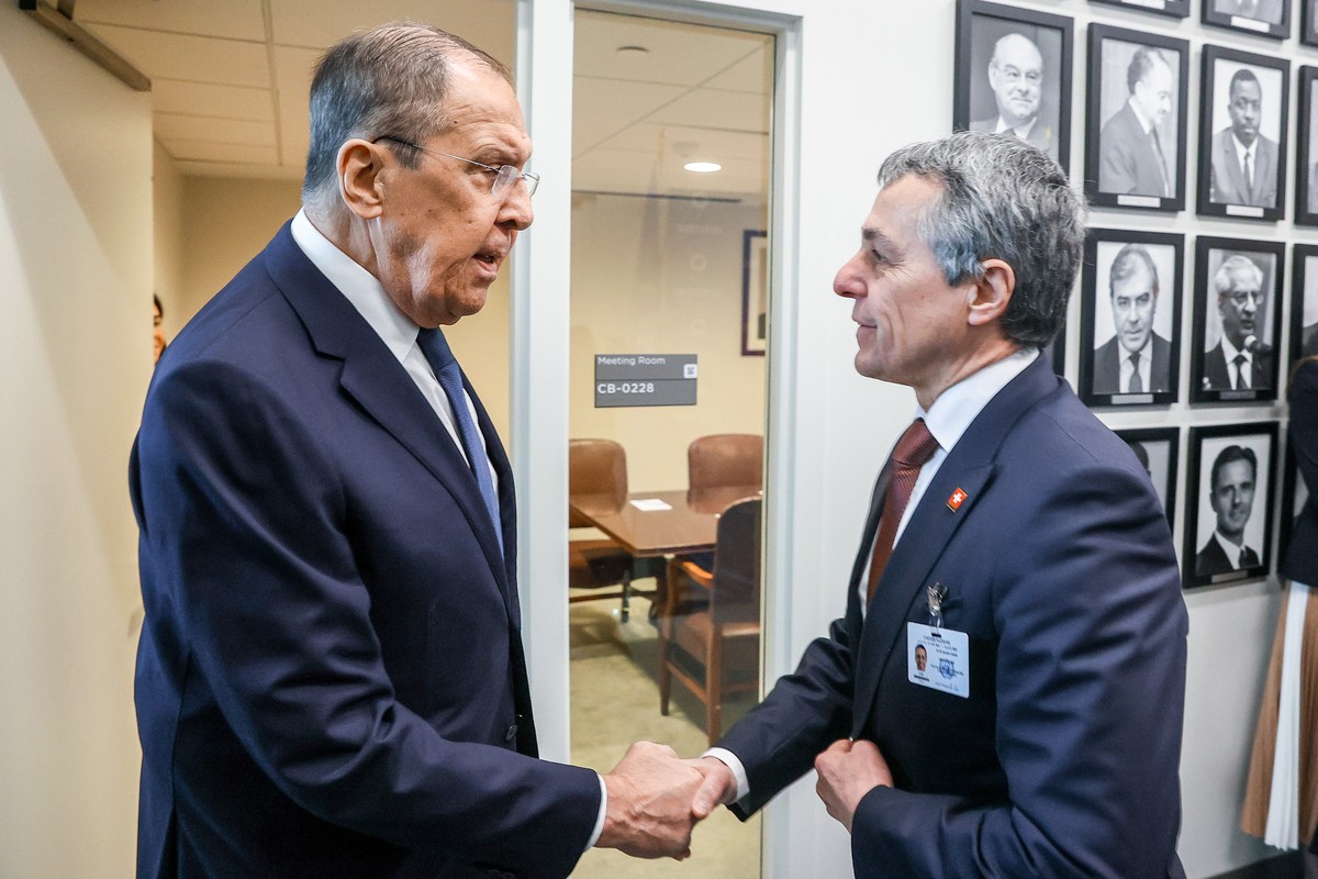 Russia's Foreign Minister Sergei Lavrov, left, and Switzerland's Federal Councillor for Foreign Affairs Ignazio Cassis, right, shake hands during a meeting at the United Nations headquarters ...