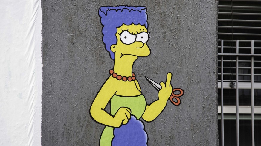 epa10235592 The Cut 2, the sequel, a mural created by the street artist AleXsandro Palombo shows Marge Simpson, a character in the animated sitcom &#039;The Simpsons,&#039; shows her &#039;middle fing ...