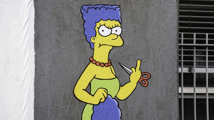 epa10235592 The Cut 2, the sequel, a mural created by the street artist AleXsandro Palombo shows Marge Simpson, a character in the animated sitcom 'The Simpsons,' shows her 'middle fing ...