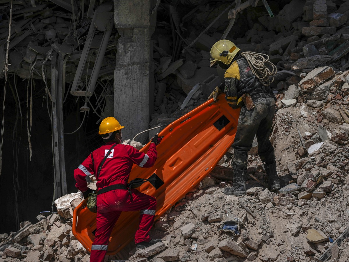 Rescuers carry a stretcher at the site of Friday's deadly explosion that destroyed the five-star Hotel Saratoga, in Havana, Cuba, Saturday, May 7, 2022. (AP Photo/Ramon Espinosa)