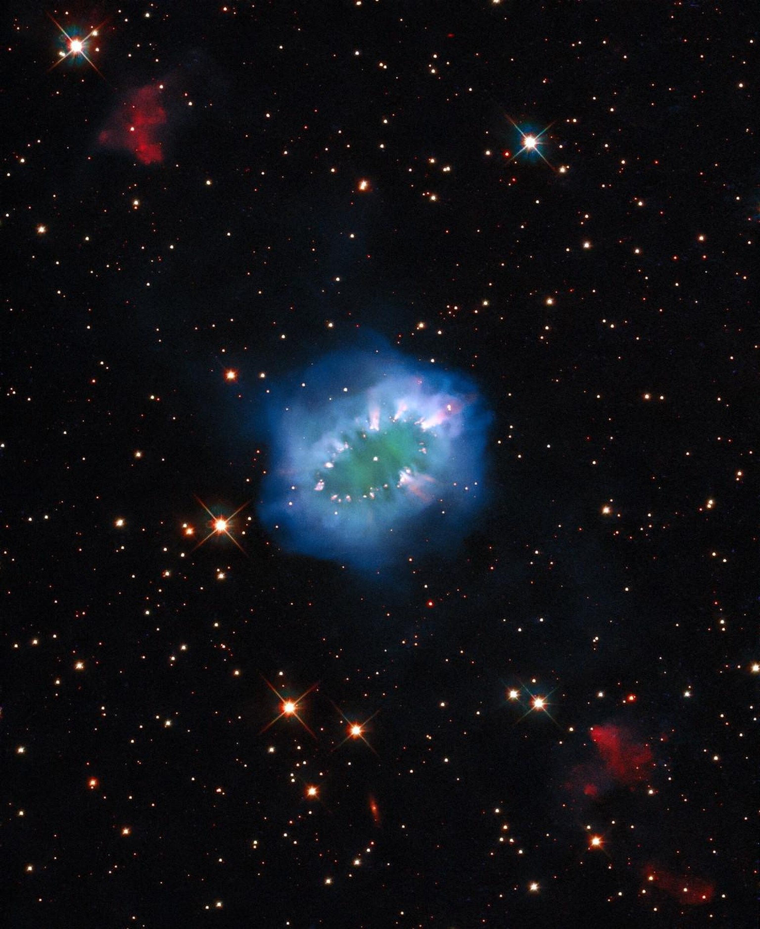 The interaction of two doomed stars has created this spectacular ring adorned with bright clumps of gas — a diamond necklace of cosmic proportions. Fittingly known as the Necklace Nebula, this planeta ...