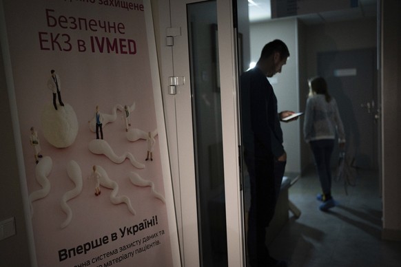 A man stands in the dark hallway of the IVMED fertility clinic during a power outage in Kiev, Ukraine, Tuesday, January 31, 2023. Some Ukrainian soldiers turn to the process of freezing sperm...