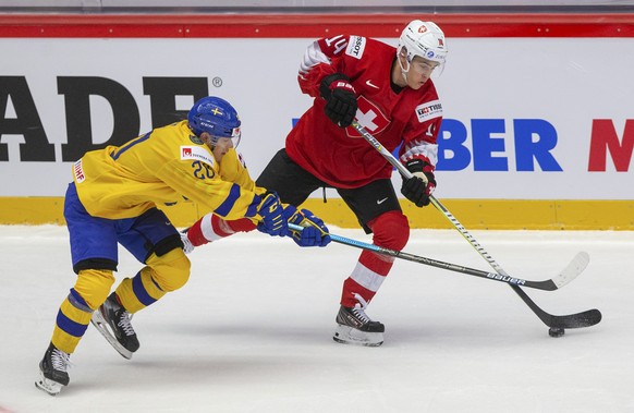Sweden's Nicola Pasic, left, and Switzerland's Sandro Schmid in action during the 2020 IIHF World Junior Ice Hockey Championships Group A match between Switzerland and Sweden in Trinec, Czec ...