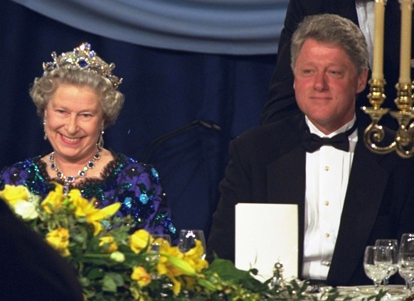 FILE - In this Saturday, June 4, 1994 file photo, Britain&#039;s Queen Elizabeth smiles, as she sits alongside President Bill Clinton at a dinner in the Guildhall in Portsmouth, England, commemorating ...