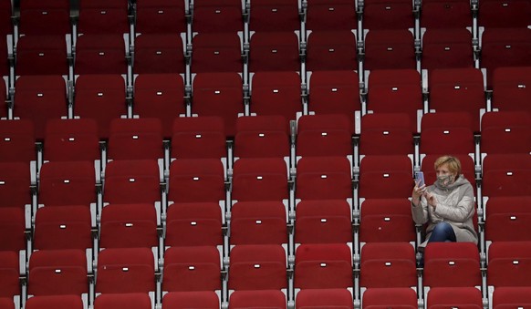 epa09240608 A lone spectator in the stands during the IIHF Ice Hockey World Championship 2021 group B match between Canada and Finland at the Arena Riga, Latvia, 01 June 2021. EPA/TOMS KALNINS