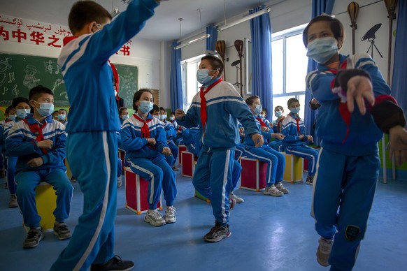 Schoolchildren dance during a music class at a primary school in Awati Township in Kashgar in western China&#039;s Xinjiang Uyghur Autonomous Region, as seen during a government organized trip for for ...