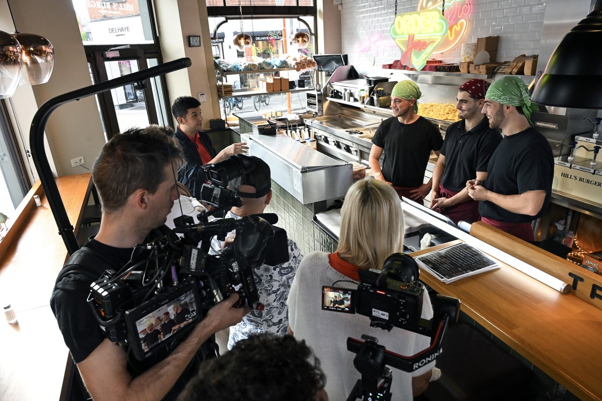 A television cameraman films during the shooting of an episode of the TV show "La meilleure friterie" ("The best fry shop") in a speciality restaurant in Brussels on September 17,  ...