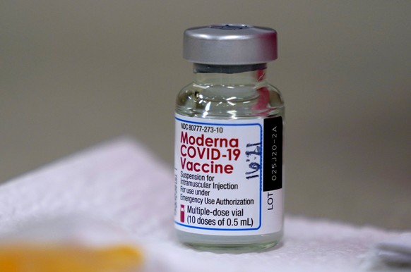 FILE - In this file photo dated Wednesday, Dec. 30, 2020, a bottle of Moderna COVID-19 vaccine on a table before being utilised in Topeka, USA. Britain has authorized a coronavirus vaccine developed b ...