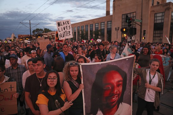 Supporters of Philando Castile held a portrait of Castile as they marched along University Avenue in St. Paul, Minn., leaving a vigil at the state Capitol on Friday, June 16, 2017. The vigil was held  ...