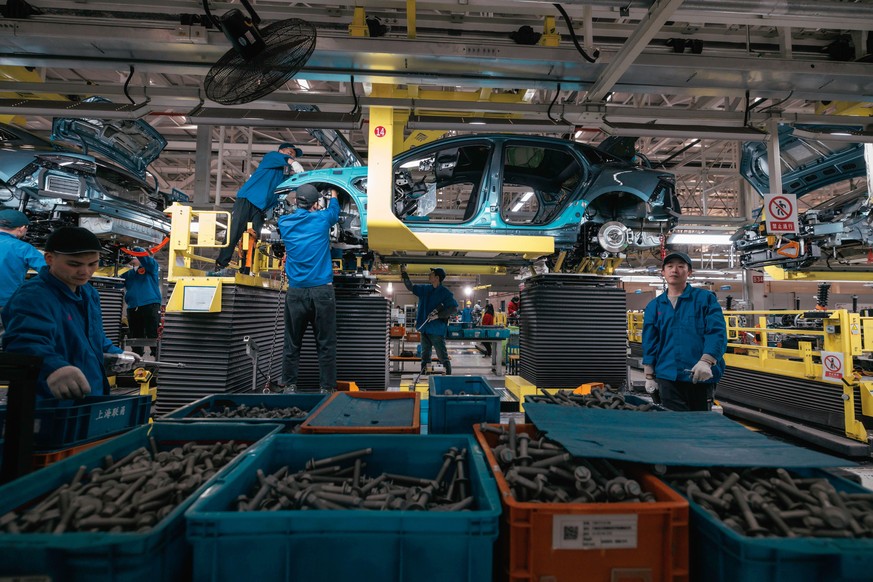 epa10974398 People work at the BYD electric car factory in Changzhou, Jiangsu province, China, November 14, 2023. According to published data, the BYD Changzhou base's production from January to July this year...