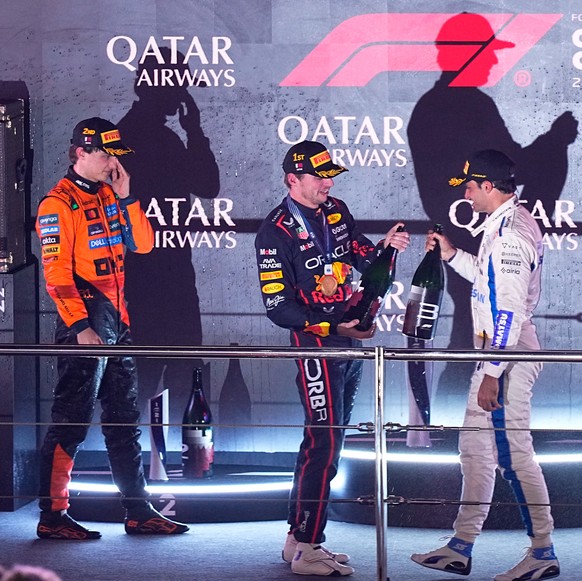 Winner Red Bull driver Max Verstappen of the Netherlands, centre, second placed McLaren driver Oscar Piastri of Australia, left, and third placed Williams driver Carlos Sainz of Spain celebrate on the ...