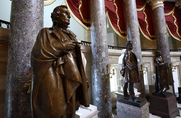 epa08563011 A statue of Jefferson Davis (L), president between 1861-65 of the self-proclaimed Confederate States of America, stands inside the US Capitol in Washington, DC, USA, 23 July 2020. On 22 Ju ...