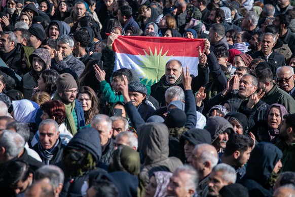 epa12665239 Pro-Kurdish protesters hold a Kurdistan flag as they attempt to walk to the Kurdish-managed northeastern Syrian city of Qamishli during a demonstration in support of Syrian Kurds, in Nusay ...