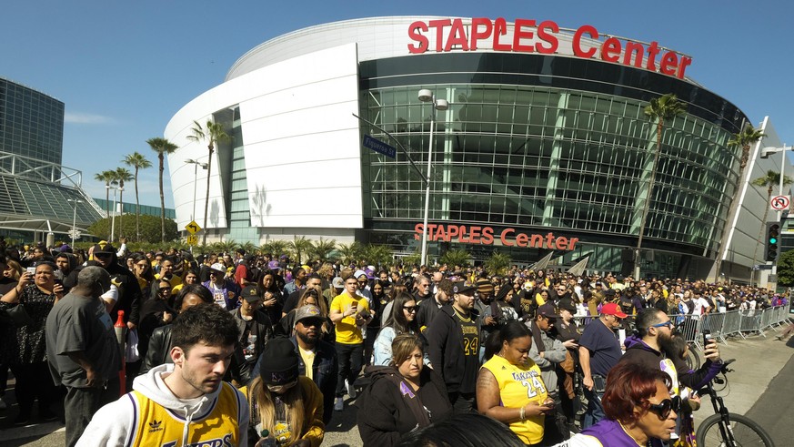 FILE - In this Feb. 24 2020, file photo, fans leave the Staples Center after a public memorial for former Los Angeles Lakers star Kobe Bryant and his daughter, Gianna, in Los Angeles. Staple Center is ...