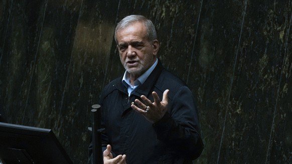 Iranian President Masoud Pezeshkian speaks in an open session of parliament to debate on his next year's budget bill, in Tehran, Iran, Tuesday, Oct. 29, 2024. (AP Photo/Vahid Salemi)