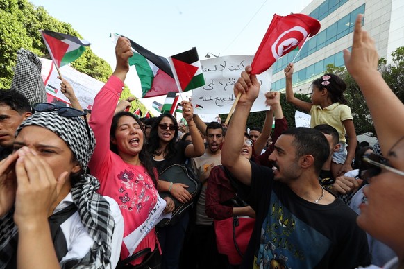 epa10927419 People take part in an anti-Israel protest to show solidarity with the Palestinian people after the Gaza hospital blast, in Tunis, Tunisian, 19 October 2023. According to Palestinian autho ...