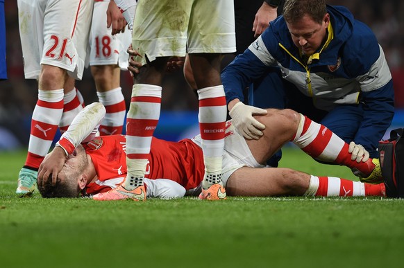 Arsenal’s Jack Wilshere lies injured during the English Premier League soccer match between Arsenal and Manchester United at the Emirates Stadium, London, Saturday, Nov. 22, 2014. (AP Photo/Tim Ireland)