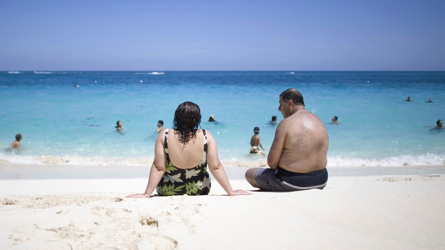 Tourists sunbathe along the beach in Nassau, Bahamas, Saturday, Sept. 6, 2008. Hurricane Ike is due to arrive in the Bahamas late Sunday. (AP Photo/Alexandre Meneghini)