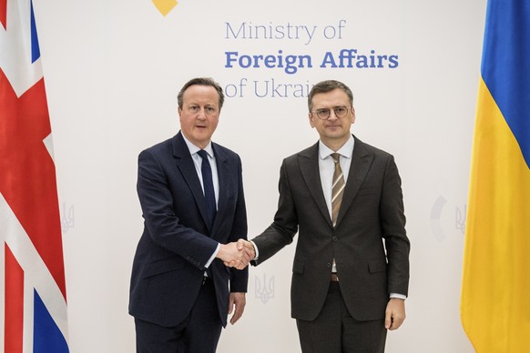 epa11316169 A handout video made available by Ukraine&#039;s Foreign Ministry Press Service shows Ukrainian Foreign Minister Dmytro Kuleba (R) and British Foreign Secretary David Cameron (L) shaking h ...