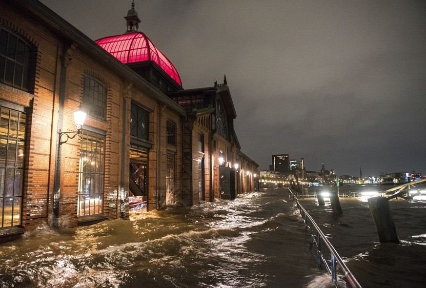 The fish market with the fish auction hall is flooded in the during a storm in Hamburg, Germany, Thursday, Feb. 17, 2022. Storm