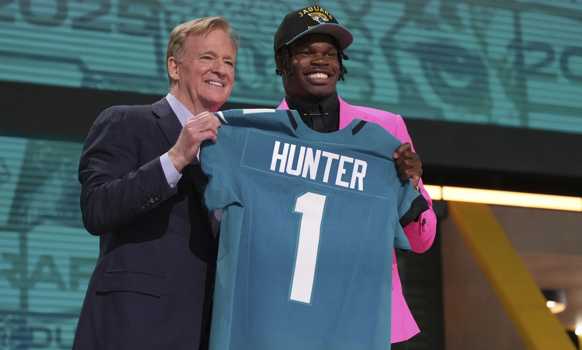 Colorado wide receiver Travis Hunter, right, poses with NFL Commissioner Roger Goodell after being chosen by the Jacksonville Jaguars with the second overall pick during the first round of the NFL foo ...