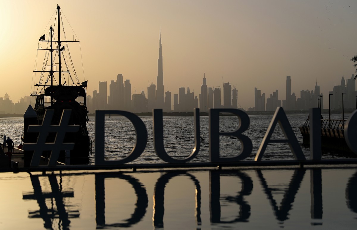 epa08966937 The sun sets behind the world's tallest completed building, the Burj Khalifa (rear C), rising high in the skyline above all other buildings of Dubai, United Arab Emirates, 26 January  ...