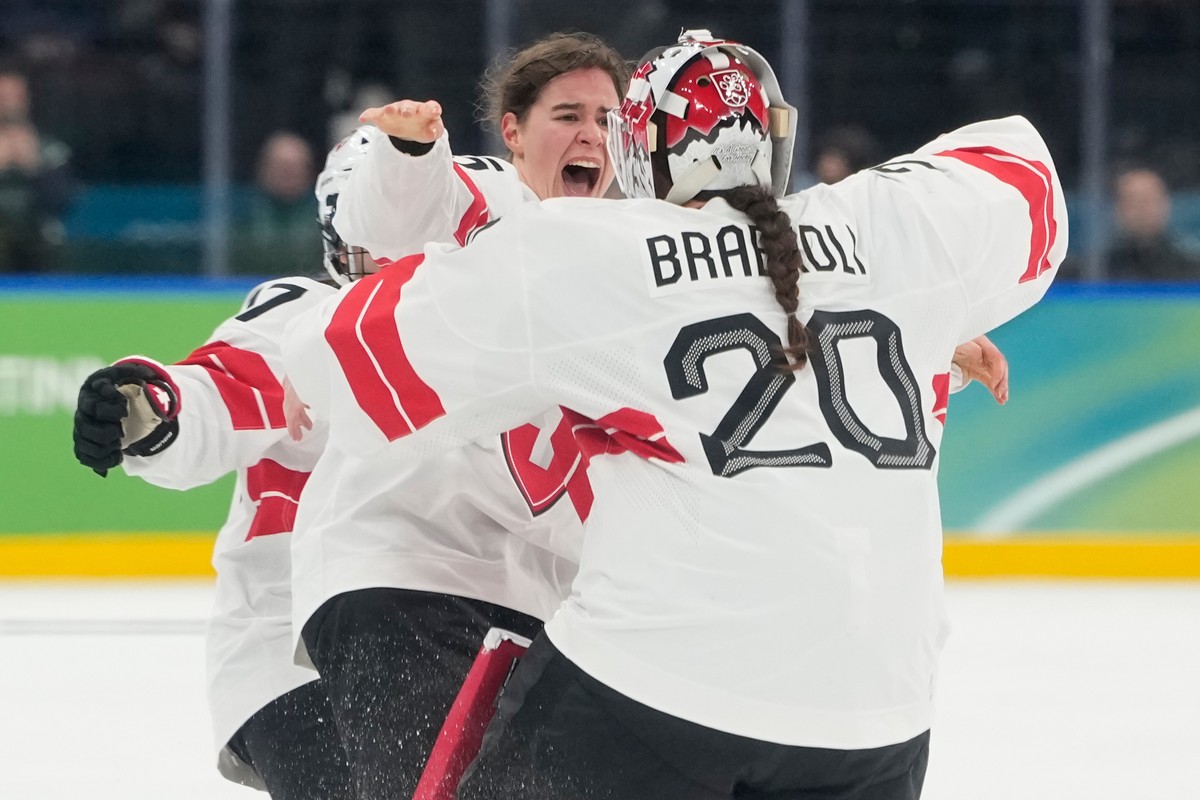Switzerland's Alina Muller (25) celebrates with Switzerland's Andrea Braendli (20) after a women's ice hockey bronze medal game between Switzerland and Sweden at the 2026 Winter Olympic ...