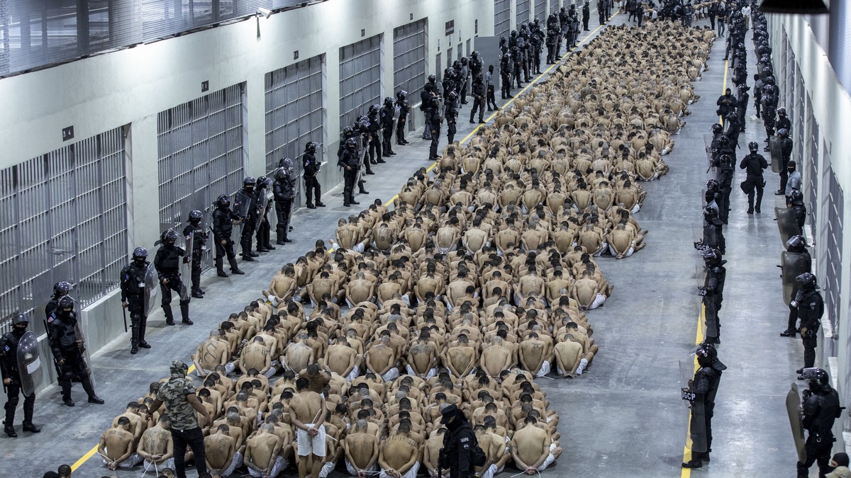 In this photo provided by El Salvador's presidential press office, inmates identified by authorities as gang members are seated on the prison floor of the Terrorism Confinement Center in Tecoluca ...