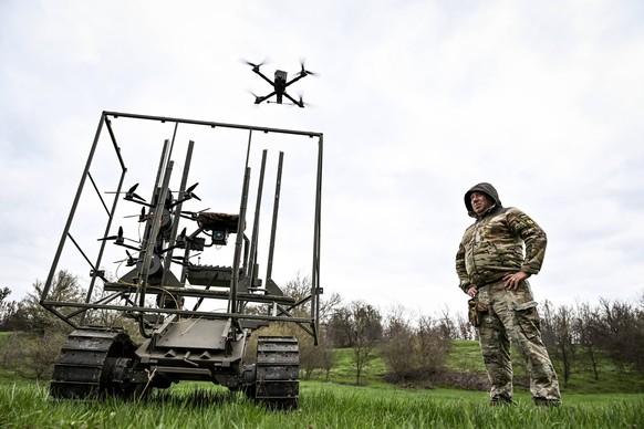 Ukrainian developers and military tested ground robotic complexes A soldier with the call sign Pavuk Spider watches a drone take off from a ground robotic complex during trials at a training ground on ...
