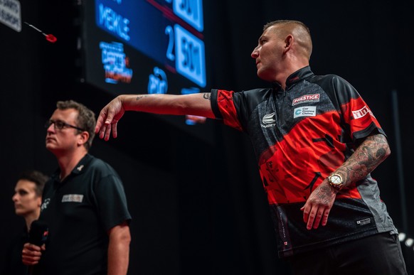 epa10160713 Nathan Aspinall of Britain plays against his compatriot Ryan Meikle during the finals of the 2022 Hungarian Darts Trophy of the PDC European Tour series in BOK Sports Hall in Budapest, Hun ...