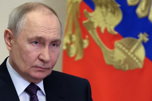 Russian President Vladimir Putin attends a ceremony to open new transport infrastructure facilities via videoconference at the Novo-Ogaryovo state residence, outside Moscow, Tuesday, March 31, 2026. ( ...