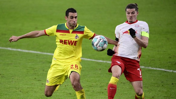 epa08893910 Ellyes Skhiri of 1.FC Koeln is put under pressure by Marcel Sabitzer of RB Leipzig (R) during the Bundesliga match between RB Leipzig and 1. FC Cologne at Red Bull Arena in Leipzig, German ...