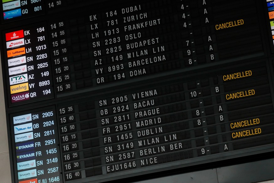 epa09651608 An information board showing several cancelled flights is seen as on-board staff of the airline company Brussels Airlines start a 24-hour strike at Brussels Airport in Zaventem, Belgium, 2 ...