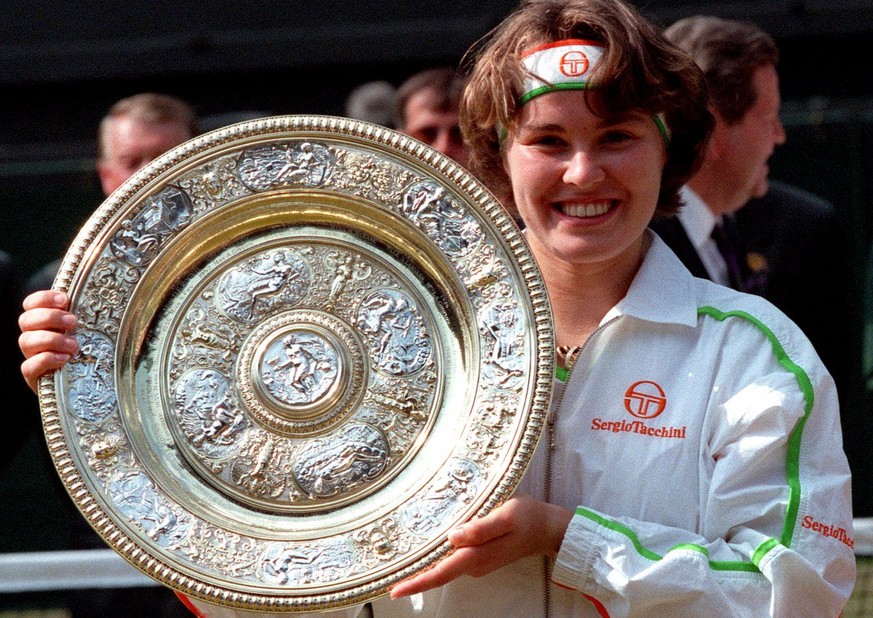 Martina Hingis holds her trophy, after defeating Jana Novotna in the Women&#039;s Singles final on the Centre Court at Wimbledon, July 5, 1997. Hingis won the final 2-6, 6-3, 6-3, to become the younge ...