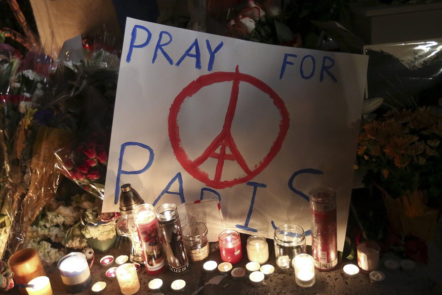 A &quot;Pray for Paris&quot; sign is pictured at a makeshift memorial outside the consulate of France to commemorate the attacks in Paris, in the Manhattan borough of New York November 14, 2015. REUTE ...