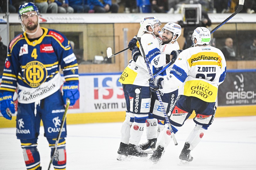 Ambri-Piotta quarterback Philip Chlapek is delighted with his 2-2 win, pictured left by Davos' Aaron Irving, during the National League ice hockey game between HC Davos and HC Ambri-Piotta, on Tuesday, 2 ...