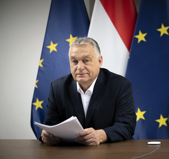 epa11925360 A handout photo made available by the Prime Minister&#039;s Press Office shows Hungarian Prime Minister Viktor Orban attending a video conference with EU leaders in his office in Budapest, ...