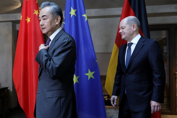 epa11160965 German Chancellor Olaf Scholz (R) and Director of the Office of the Central Foreign Affairs Commission of the Chinese Communist Party Wang Yi (L) walk next to each other during bilateral t ...