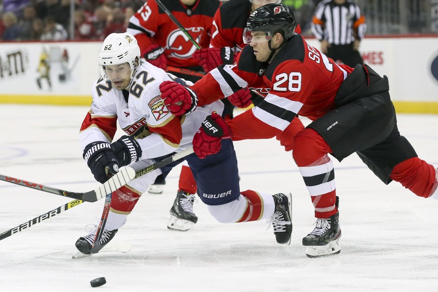 Florida Panthers center Denis Malgin (62) skates against New Jersey Devils defenseman Damon Severson (28) during the third period of an NHL hockey game, Monday, Oct. 14, 2019, in Newark, N.J. The Pant ...